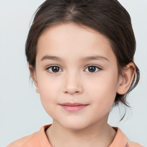 Joyful white child female with medium  brown hair and brown eyes