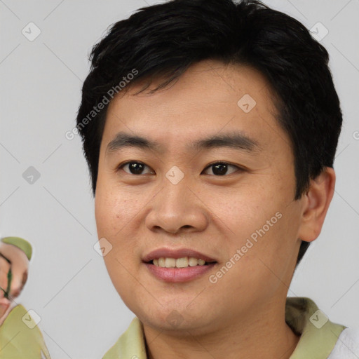 Joyful asian young-adult male with short  black hair and brown eyes
