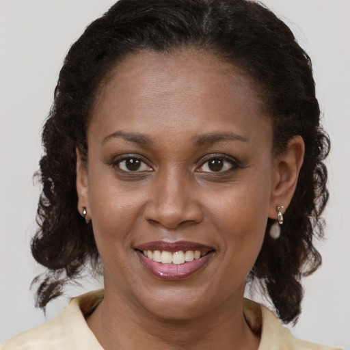 Joyful black young-adult female with medium  brown hair and brown eyes