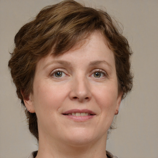 Joyful white adult female with medium  brown hair and grey eyes