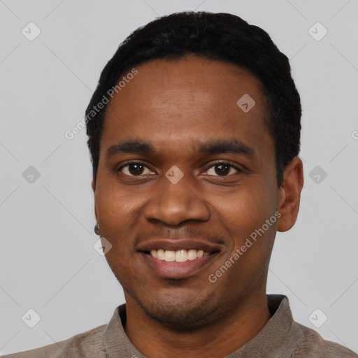 Joyful black young-adult male with short  black hair and brown eyes