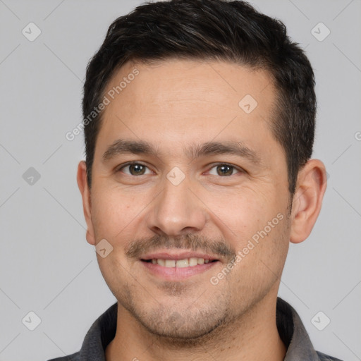 Joyful white young-adult male with short  brown hair and brown eyes