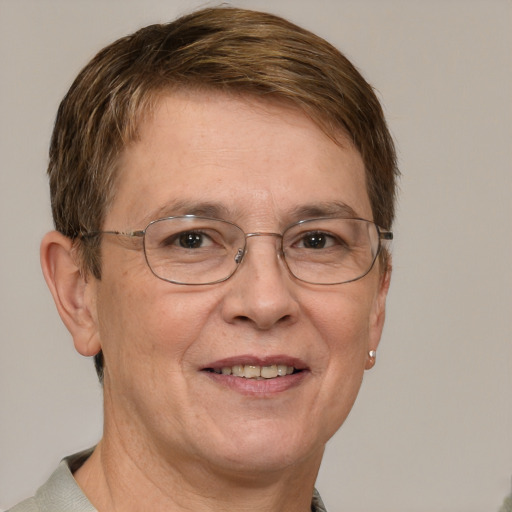 Joyful white middle-aged female with short  brown hair and blue eyes