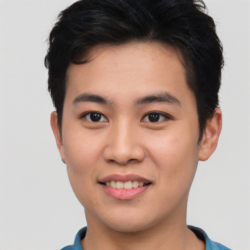 Joyful asian young-adult male with short  brown hair and brown eyes