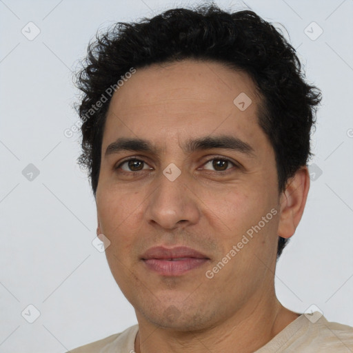 Joyful white young-adult male with short  black hair and brown eyes