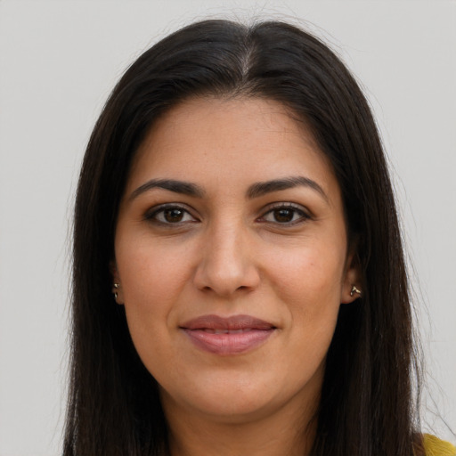 Joyful latino young-adult female with long  brown hair and brown eyes