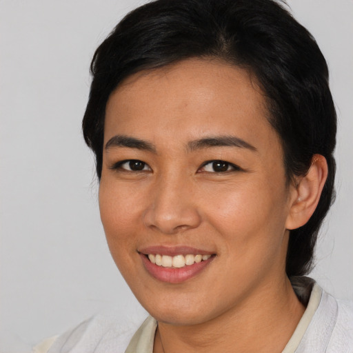 Joyful asian young-adult female with short  black hair and brown eyes