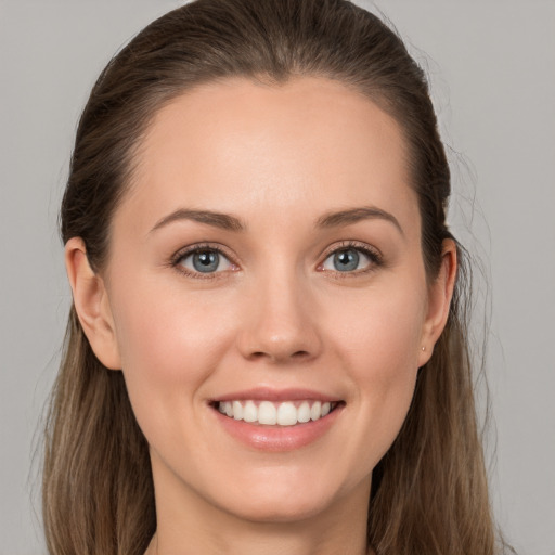 Joyful white young-adult female with long  brown hair and grey eyes