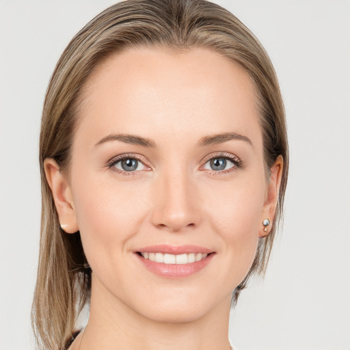 Joyful white young-adult female with long  brown hair and grey eyes