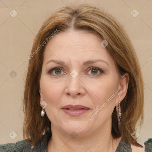 Joyful white adult female with medium  brown hair and green eyes