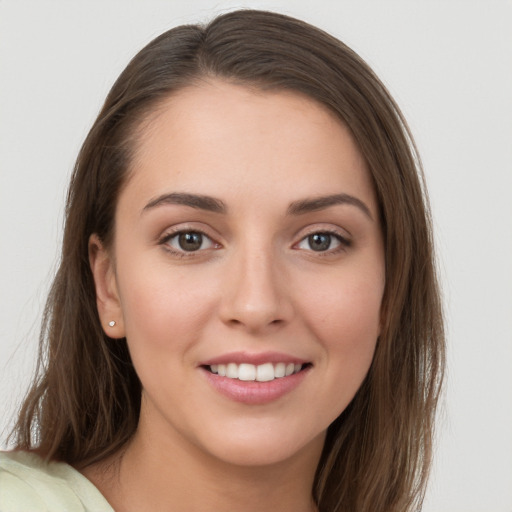 Joyful white young-adult female with long  brown hair and grey eyes