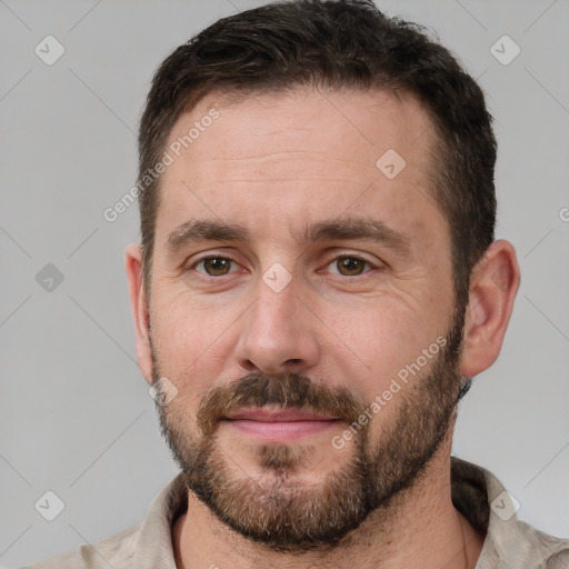 Joyful white adult male with short  brown hair and brown eyes