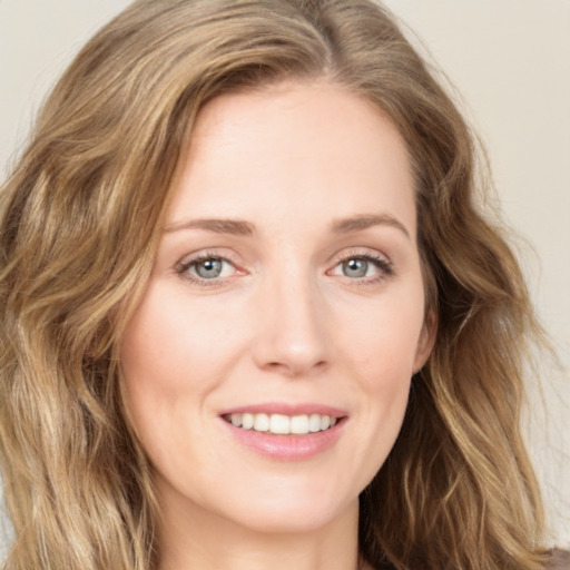 Joyful white young-adult female with long  brown hair and green eyes