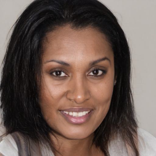 Joyful black young-adult female with medium  brown hair and brown eyes