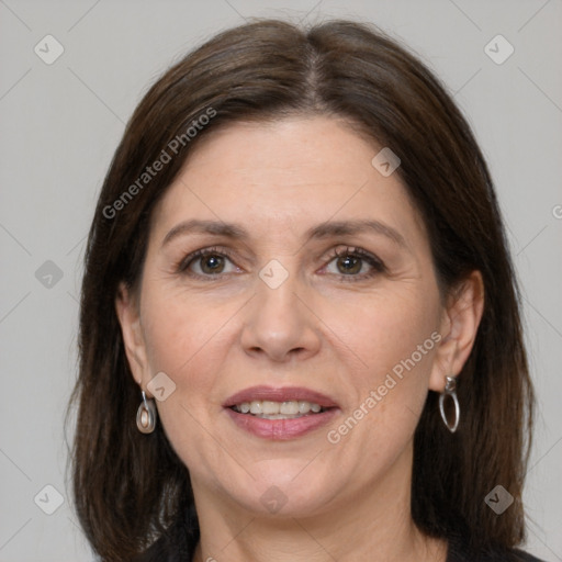 Joyful white adult female with medium  brown hair and grey eyes