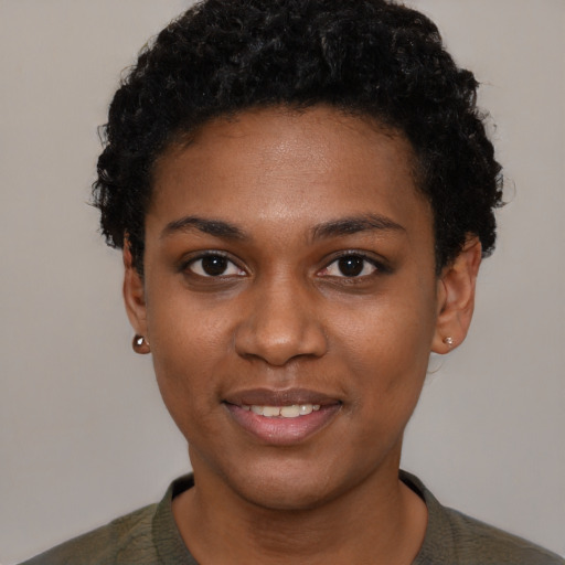 Joyful black young-adult female with short  black hair and brown eyes