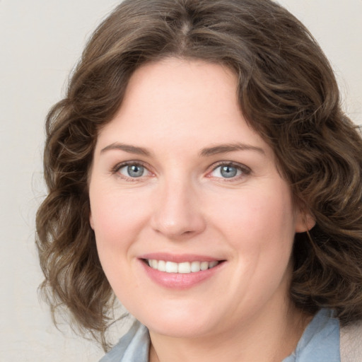 Joyful white young-adult female with medium  brown hair and blue eyes