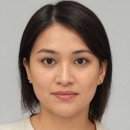 Joyful latino young-adult female with medium  brown hair and brown eyes