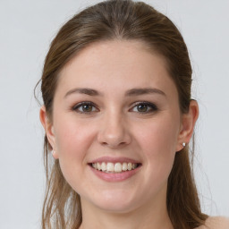 Joyful white young-adult female with long  brown hair and grey eyes