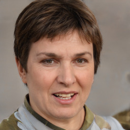 Joyful white adult female with medium  brown hair and grey eyes