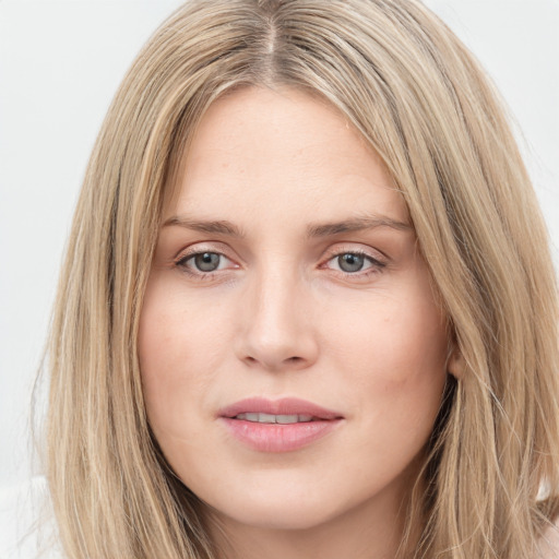 Joyful white young-adult female with long  brown hair and green eyes