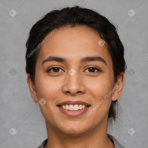 Joyful latino young-adult female with short  black hair and brown eyes