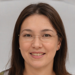 Joyful white adult female with long  brown hair and brown eyes