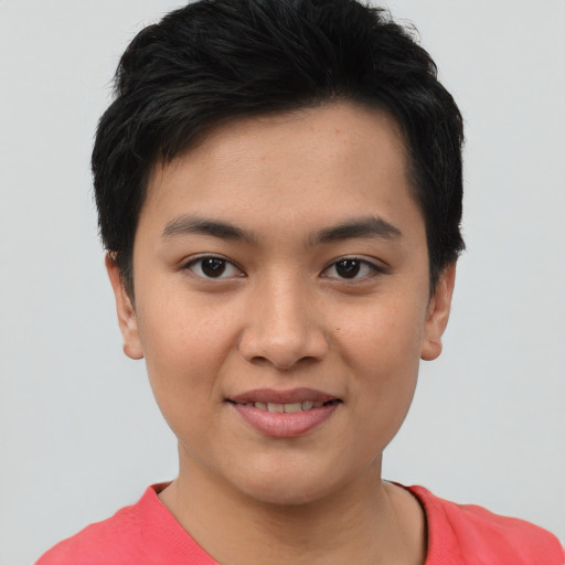 Joyful asian young-adult female with short  brown hair and brown eyes