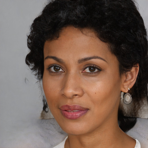 Joyful black young-adult female with medium  brown hair and brown eyes