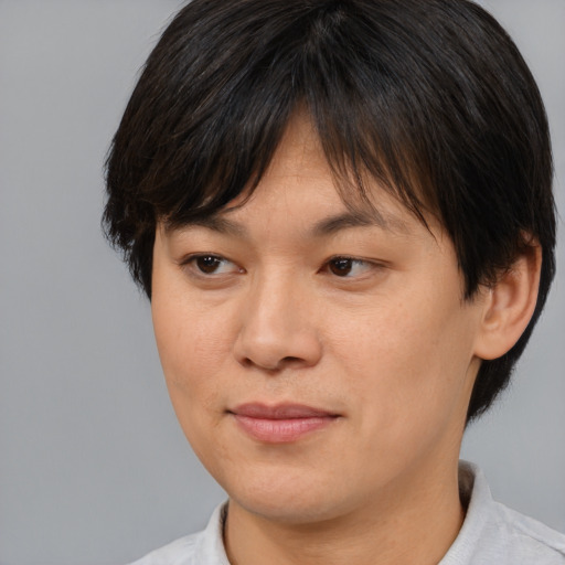 Joyful asian adult female with medium  brown hair and brown eyes