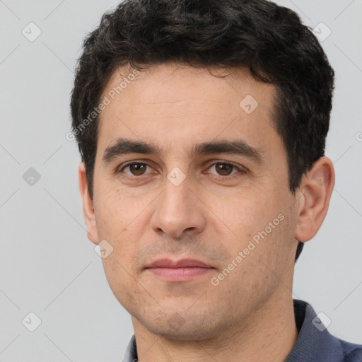 Joyful white young-adult male with short  black hair and brown eyes