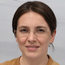 Joyful white adult female with medium  brown hair and brown eyes