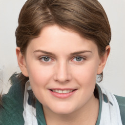 Joyful white young-adult female with medium  brown hair and blue eyes