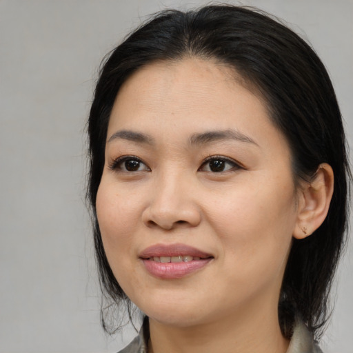 Joyful asian young-adult female with medium  brown hair and brown eyes