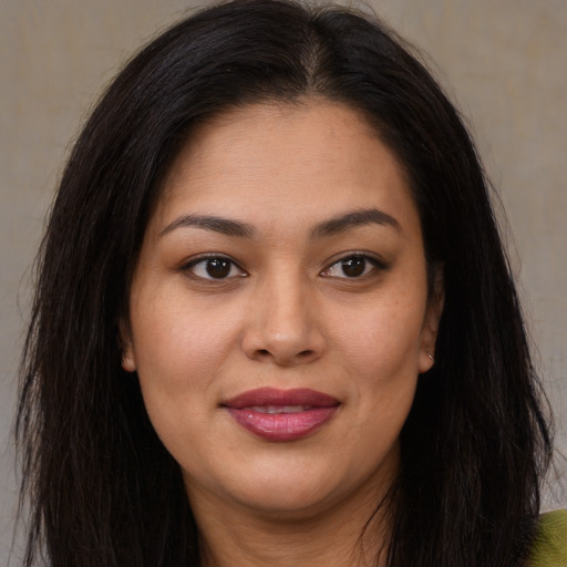 Joyful asian young-adult female with long  brown hair and brown eyes