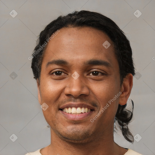 Joyful latino young-adult male with short  black hair and brown eyes