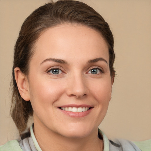 Joyful white young-adult female with medium  brown hair and grey eyes