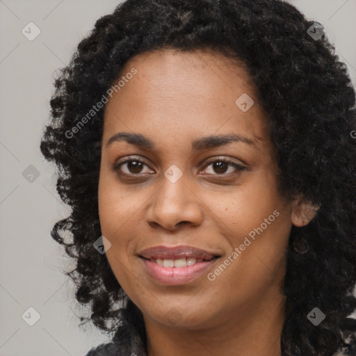 Joyful black young-adult female with long  black hair and brown eyes