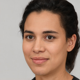 Joyful latino young-adult female with medium  brown hair and brown eyes