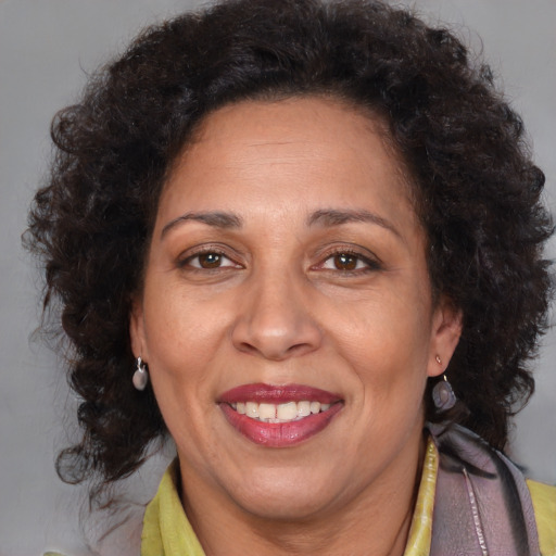 Joyful black adult female with medium  brown hair and brown eyes