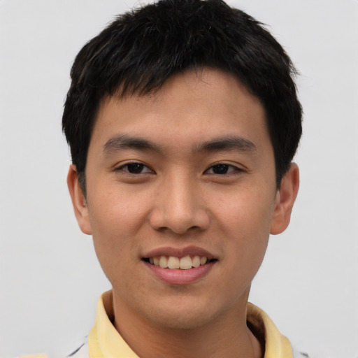 Joyful asian young-adult male with short  black hair and brown eyes