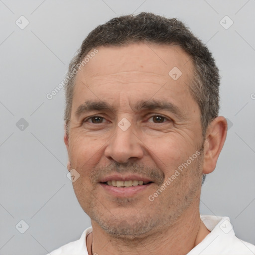 Joyful white adult male with short  brown hair and brown eyes