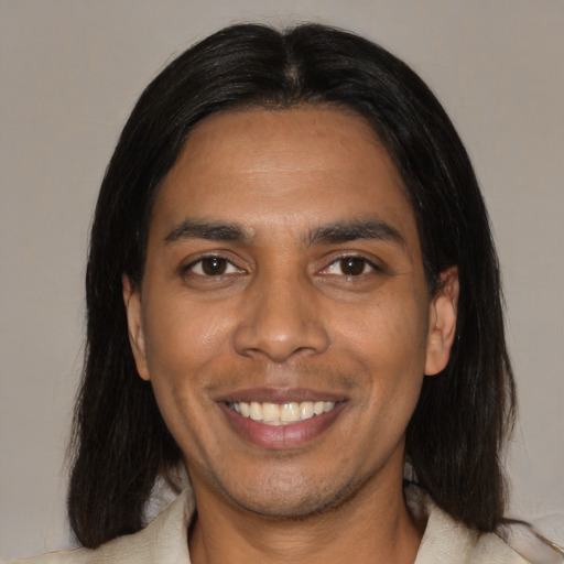 Joyful black young-adult male with medium  brown hair and brown eyes