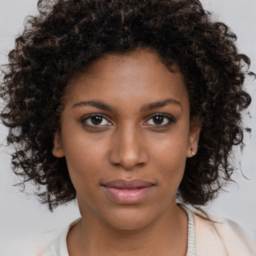 Neutral black young-adult female with medium  brown hair and brown eyes