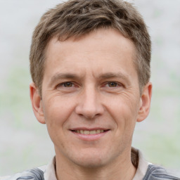 Joyful white adult male with short  brown hair and brown eyes