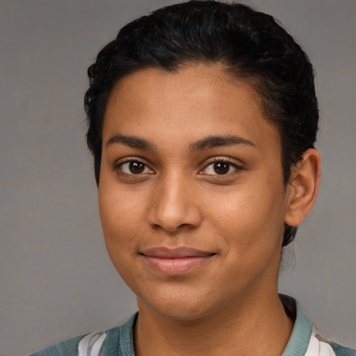 Joyful latino young-adult female with short  black hair and brown eyes