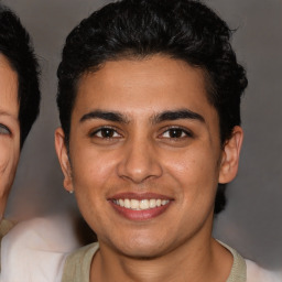 Joyful latino young-adult male with short  brown hair and brown eyes