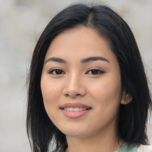 Joyful asian young-adult female with long  black hair and brown eyes