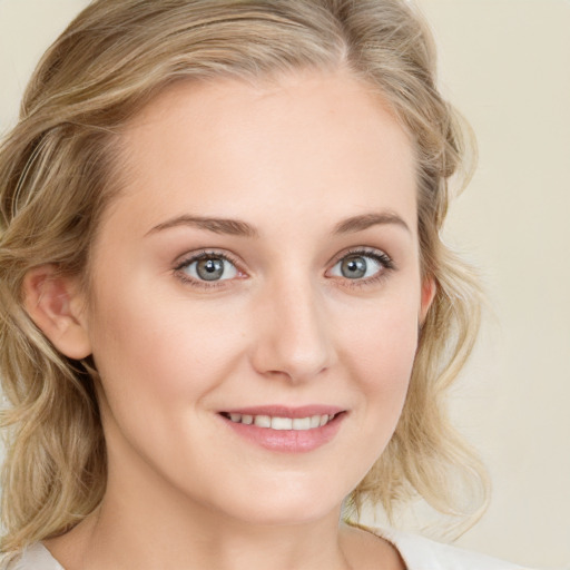 Joyful white young-adult female with long  brown hair and blue eyes