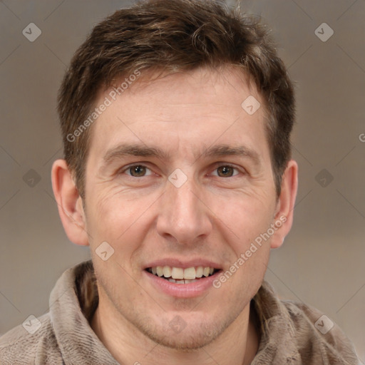 Joyful white adult male with short  brown hair and brown eyes